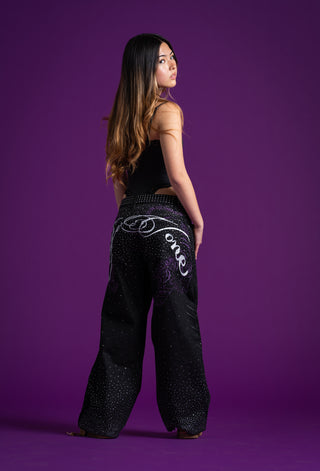 Back view of SiVone low-rise rhinestone jeans with signature embroidery